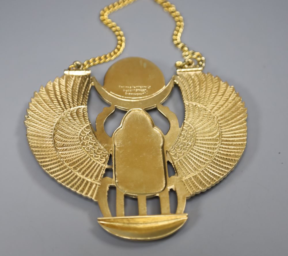 An Egyptian design gilt metal and enamel scarab beetle pendant on chain, by Thomas Fattorini Ltd